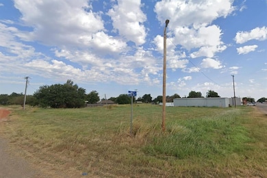 Street view of vacant lot - zoned commercial.