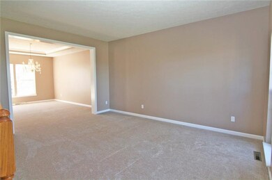 The living room is open to the dining room for a g