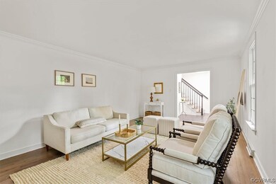 Living room with light hardwood flooring and crown