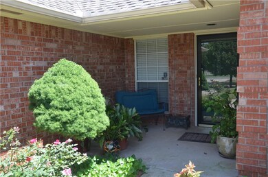 Covered porch with a storm front door and gutters 