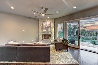 Living area with wood finished floors, a fireplace, a ceiling fan, and recessed lighting