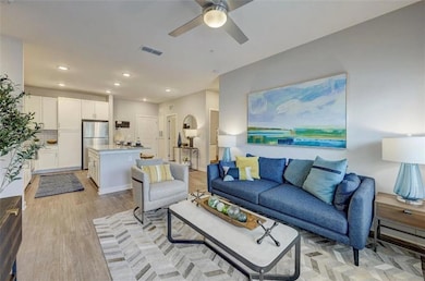Living room featuring a ceiling fan, recessed ligh