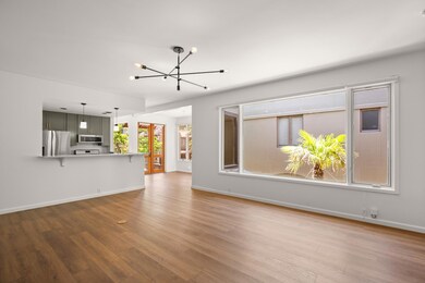 Unfurnished living room with a chandelier, wood f