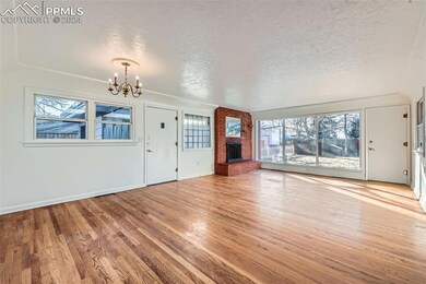 Spacious living room featuring a wood fireplace, w