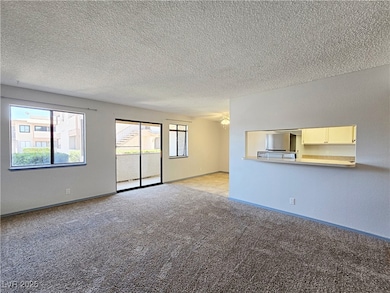 Unfurnished living room with light colored carpet,