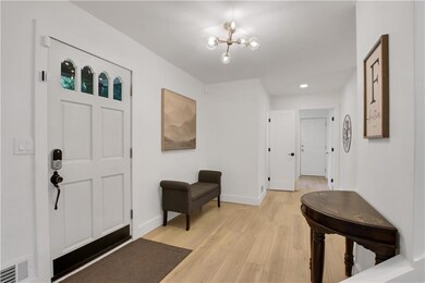 Entrance foyer with light wood-style flooring, a chandelier, and recessed lighting