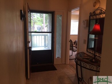 The ceramic tiled foyer leading onto the front por