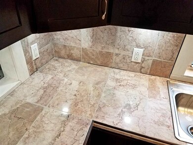 Marble counter tops illuminated by custom touch free under cabinet led lighting