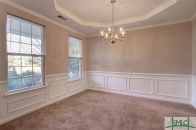 Dining Room with tray ceiling and lots of light