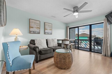 Living room featuring visible vents, ceiling fan, 