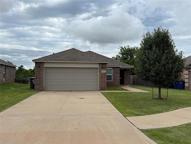 Single story home featuring brick siding, driveway, and a shingled roof