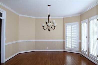 Dining room has lots of natural light, hardwoods & updated lighting