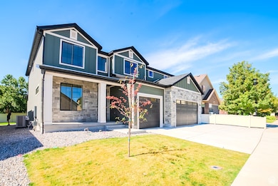 View of front of house with stone siding, driveway, covered porch, and a garage