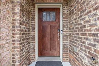 Doorway to property with brick siding