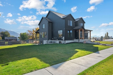 View of side of property with board and batten siding, a mountain view, and covered porch