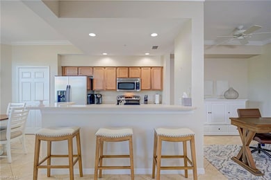 Kitchen with crown molding, a breakfast bar, and s