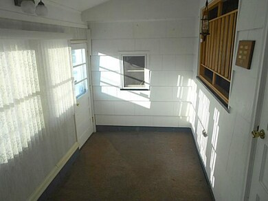 Exterior Front. Step down sun room off breezeway.
