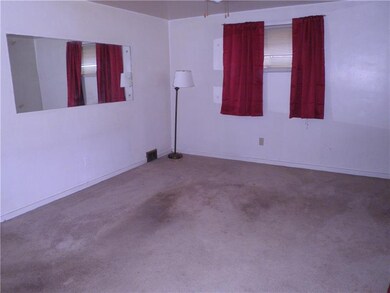 Living room with hardwood under the carpet
