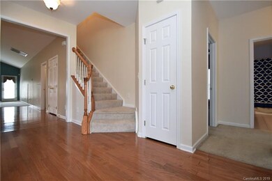 Walking into the Entry Hall of the home. Handsome hardwood floors. Neutral paint.