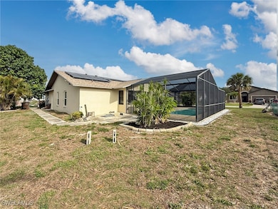 Back of property featuring roof mounted solar pane