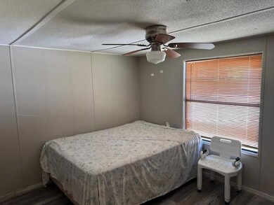 Bedroom featuring wood finished floors and ceiling fan