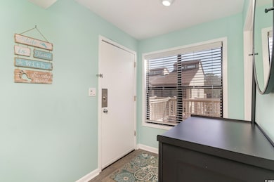Entryway with baseboards and wood finished floors