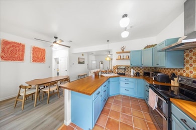 Kitchen featuring wood counters, double oven rang