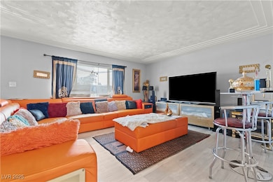 Living area featuring a textured ceiling and wood