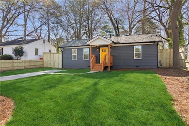 Ranch-style home with crawl space, roof with shingles, a front yard, and fence