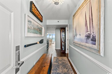 Corridor with dark wood-type flooring and baseboar
