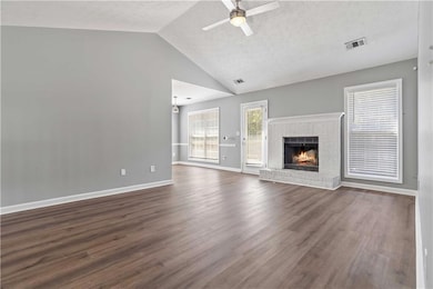Unfurnished living room featuring a textured ceili