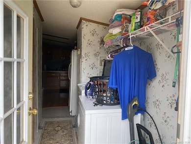 You walk into the laundry room from the side door of the home.