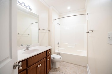 Full 2nd bathroom featuring bathing tub / shower combination, vanity, light tile patterned floors, ornamental molding, and recessed lighting
