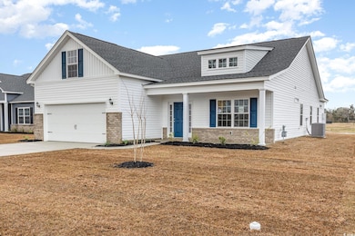 View of front of house featuring concrete driveway, a front yard, a garage, and roof with shingles