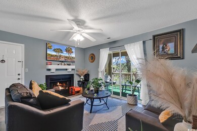 Living area with visible vents, ceiling fan, a lit
