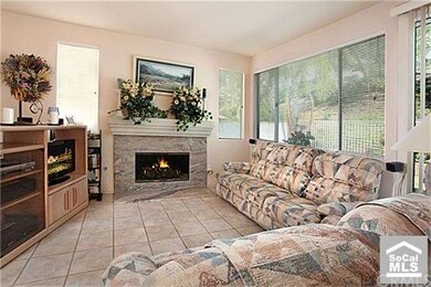 Cozy family room accented by marble fireplace.