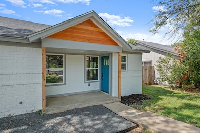 View of exterior entry featuring brick siding and