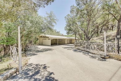 View of front of home featuring driveway, an atta