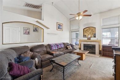 Living room with ceiling fan, visible vents, high