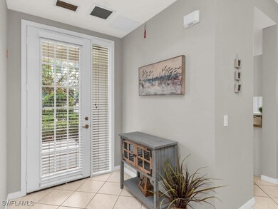 Doorway featuring light tile patterned floors