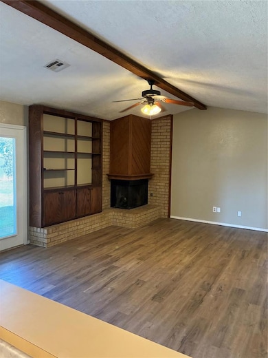 Vaulted Ceiling with Beam... Open Space... Built-In Shelves and Cedar-Wrapped Fireplace...