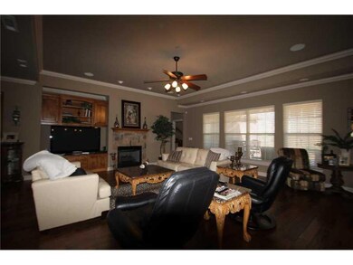 Living Room. Large living room has coffered ceiling and is open to kitchen and dining areas.