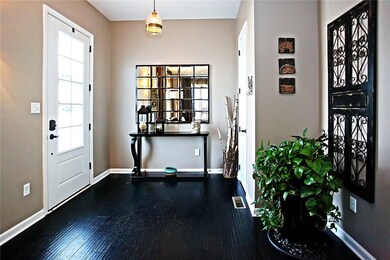 Beautiful entry with scraped style hardwood floor.