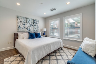 Guest bedroom with ceramic tile floors and recessed lighting
