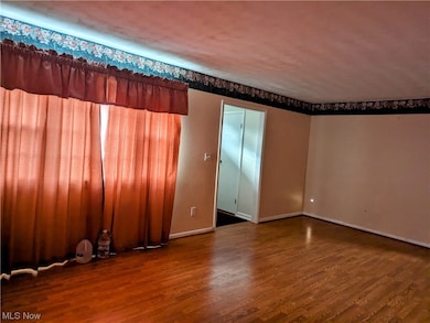Unfurnished room with dark hardwood / wood-style floors