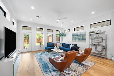Framed by a wall of transom windows and wide-plank