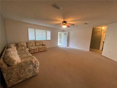 VIEW OF LIVING ROOM AND FRONT DOOR