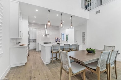 Dining space with light wood-style floors, recesse