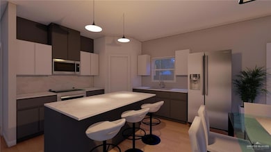 Kitchen with a center island, light countertops, a sink, and stainless steel appliances