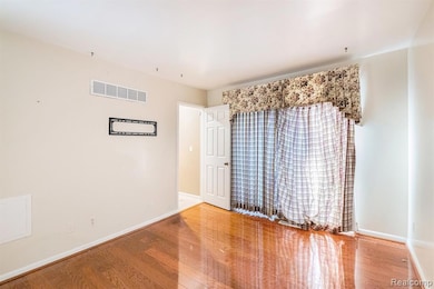 Empty room featuring wood finished floors and baseboards